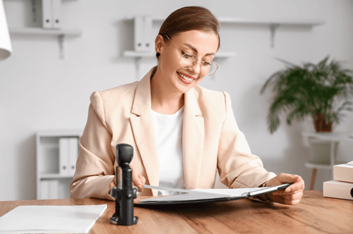 Happy notary looking at a document