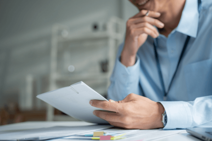 Un client lit attentivement le rapport d'inspection après sa réception