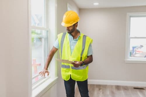 Building inspector looking at a window