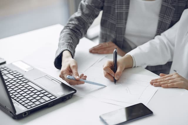 Two people looking at a computer