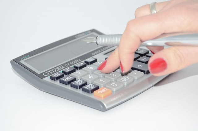 Une personne calcule un prix de vente sans courtier