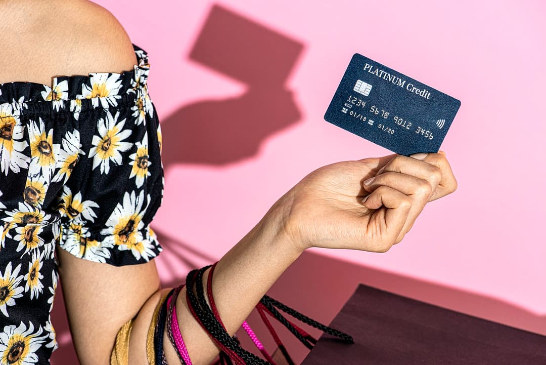 A woman with a credit card and shopping bags