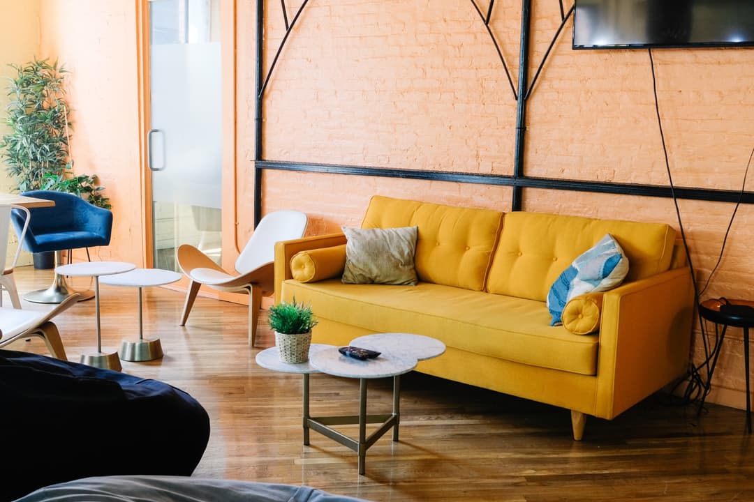 A living room with a yellow couch