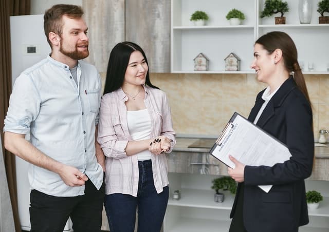 Couple d'acheteurs et courtier immobilier