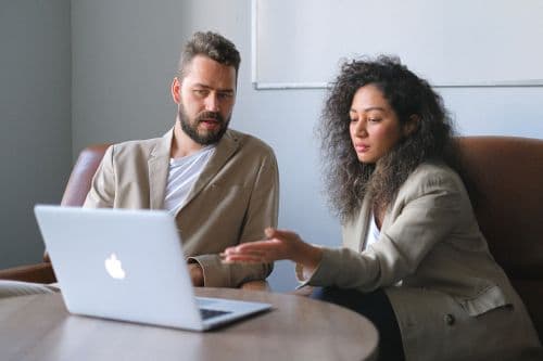 Mortgage broker explaining the home equity line of credit to a client on a computer