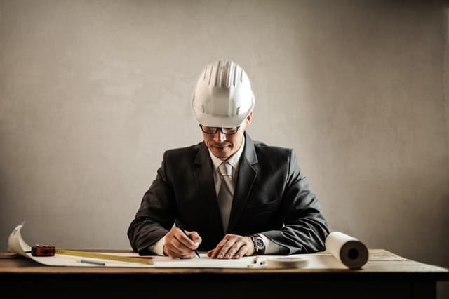 Arpenteur-géomètre faisant un plan d'implantation