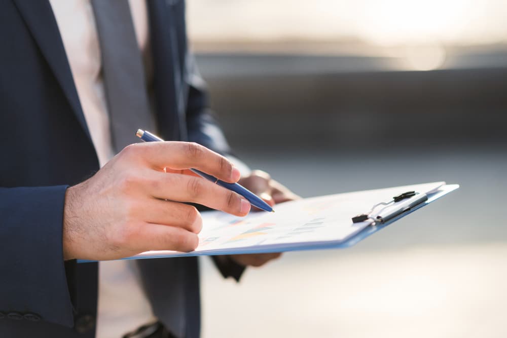 Homme listant ses biens sur un bloc-notes